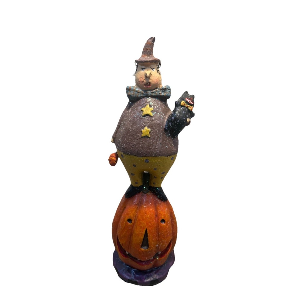 Halloween-themed folk art figurine of a person standing‎ on a jack-o'-lantern